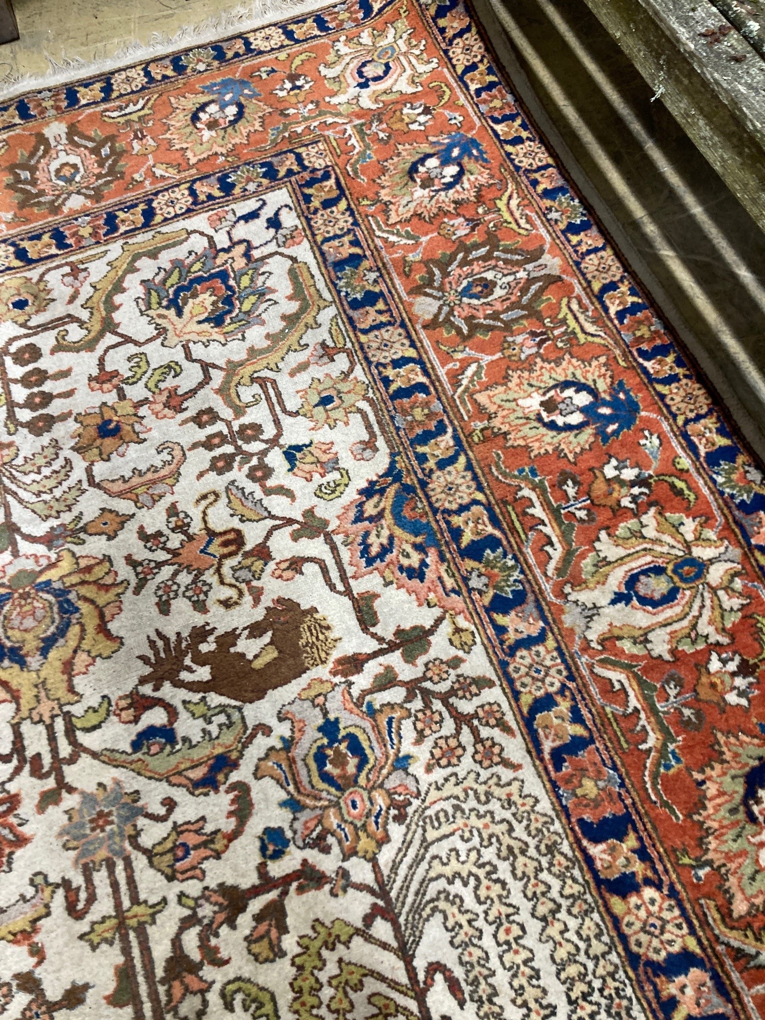 A modern Persian ivory ground rug, 340 x 260cm